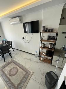 a living room with a flat screen tv on the wall at Mertcan Doruk in Side