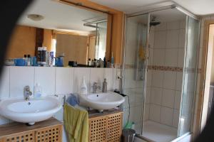a bathroom with two sinks and a shower at Toscana1 in Freimersheim +7 photos