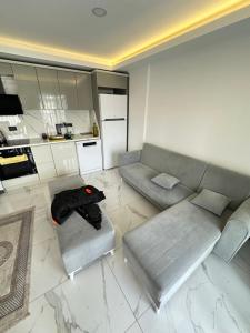 a living room with a couch and a kitchen at Mertcan Doruk in Side