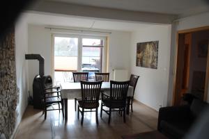 a dining room with a table and chairs at Toscana1 in Freimersheim