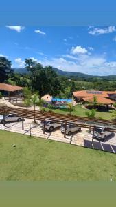 a group of benches in a park with a water park at Pousada Dona Bili in Pirenópolis