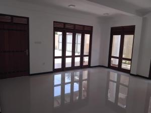 an empty room with doors and windows and a floor at Hotel & Restaurant Chingari Pinnawala in Rambukkana