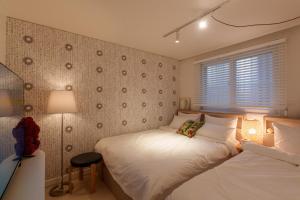 a bedroom with two beds and a window at 포레스트101 in Seoul