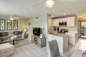 a kitchen and living room with a couch and a table at Golf Course Views! Couple's Retreat in Diamondhead in Diamondhead