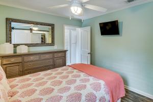 a bedroom with a bed with a dresser and a mirror at Golf Course Views! Couple's Retreat in Diamondhead in Diamondhead +16 photos