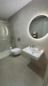 a bathroom with a sink and a toilet and a mirror at La Tejita "Vida" by BE HAPPY in La Tejita