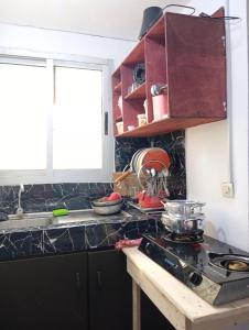 a kitchen with a sink and a counter top at Mandeko in Abidjan