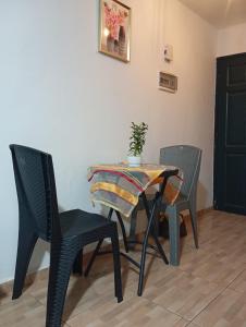 a table and chairs with a plant on top of it at Mandeko in Abidjan +5 photos