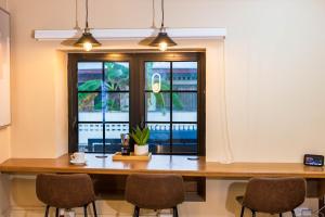 a conference room with a table and chairs and a window at TStays Smart Hotel Courtyard, Gated Modern Stay in Port-of-Spain +40 photos