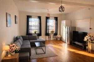 a living room with a couch and a tv at City Living Trelleborg in Trelleborg