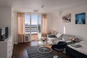a living room with a couch and a table at City Living Trelleborg in Trelleborg