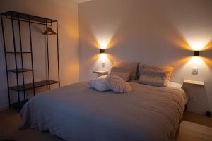 a bedroom with a bed with two lamps on it at Stories Lodewijk en Margaretha in Bruges