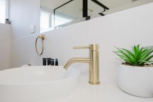a bathroom with a sink and a faucet at Palm Beach Villas by Rockingham Apartments in Rockingham