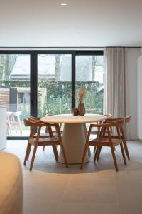 a dining room with a table and two chairs at Stories Lodewijk en Margaretha in Bruges
