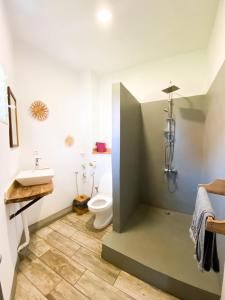 a bathroom with a toilet and a sink at Jiro Hôtel in Antananarivo +39 photos