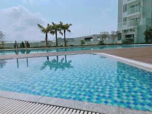 a large swimming pool in front of a building at Nera Stay Huế - Luxury Apartment in Hue