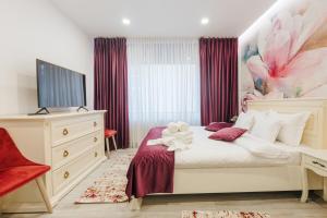 a bedroom with a bed with a teddy bear on it at Damone Residence in Gura Humorului