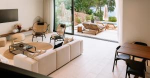 a living room with a couch and a table at Maslina Resort in Stari Grad