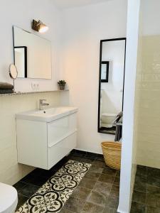 a bathroom with a sink and a toilet and a mirror at Finca Bona Nit in Jávea +43 photos