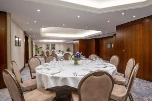 a conference room with a white table and chairs at Warwick Paris Champs-Elysées in Paris