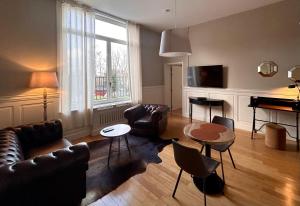 a living room with a couch and a table at Hotel Saint Georges in Mons