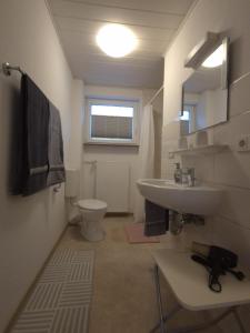 a bathroom with a sink and a toilet at Ferienwohnung Annenblick in Sankt Wendel