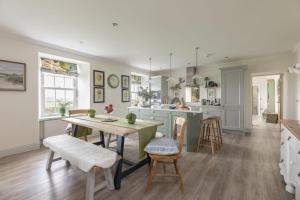 a kitchen with a table and chairs in a room at Greenhead Cottage in Kelso