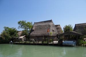 a house on a dock in the water at Apartments in Eraclea Mare 53760 in Eraclea Mare