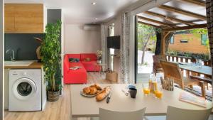 a kitchen and living room with a washer and dryer at Vic's Land Holidays in Grimaud