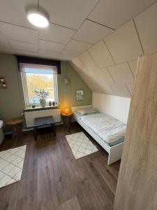 a large room with a bed and a window at Nordwind Sjut in Warnow