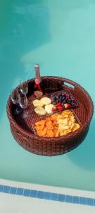 a basket filled with fruit and wine glasses on a table at Epic touch B&B in Sandton