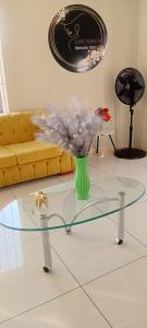 a glass table in a living room with a vase of flowers at Epic touch B&B in Sandton