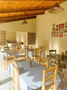 a dining room with wooden tables and chairs at Pousada Sítio Rupestre Peruaçu in Januária
