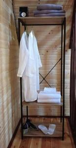 a shelf with white towels on a wooden wall at Cottage Dachi in Mestia in Mestia