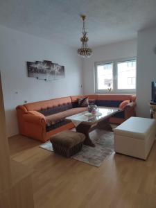 a living room with a couch and a table at Apartman Lara in Kupres