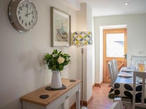 a dining room with a vase of flowers on a table at Whitehouse Farm in Hartington