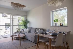a living room with a couch and a table at The Oak - Ekerum Öland in Borgholm