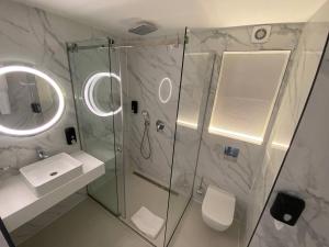 a bathroom with a shower and a sink and a mirror at Optima Collection Kamianske in Kamianske