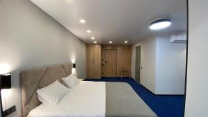 a bedroom with a large white bed in a room at Optima Collection Kamianske in Kamianske