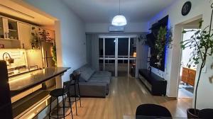 a living room with a couch and a bar at Prince 1513 in Vitória