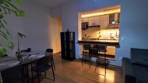 a living room with a table and a kitchen at Prince 1513 in Vitória