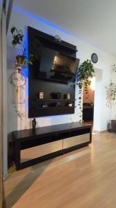 a living room with a tv on a wall at Prince 1513 in Vitória