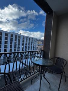 a balcony with a table and chairs on a building at AlvinaMI in Tsaghkadzor