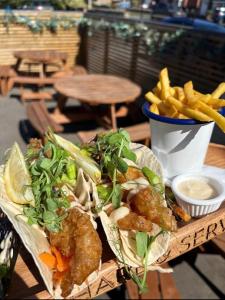 a wooden table with a tray of food and french fries at Wentworth arms in Malton