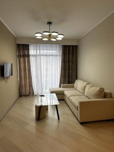 a living room with a couch and a table at AlvinaMI in Tsaghkadzor