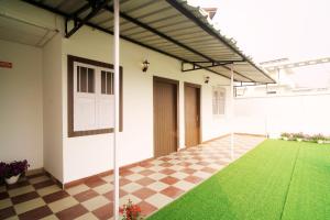 an empty house with a checkered floor and a patio at The Guwahati Penthouse in Guwahati
