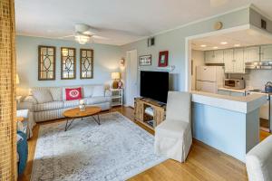 a living room with a couch and a table at Golfer's Getaway! Modern Diamondhead Condo in Diamondhead