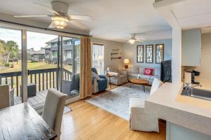 a living room with a view of a living room at Golfer's Getaway! Modern Diamondhead Condo in Diamondhead
