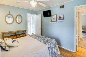 a bedroom with a bed and a ceiling fan at Golfer's Getaway! Modern Diamondhead Condo in Diamondhead +19 photos