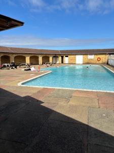 a large swimming pool with people in the water at 6 berth static in Skegness in Chapel Saint Leonards